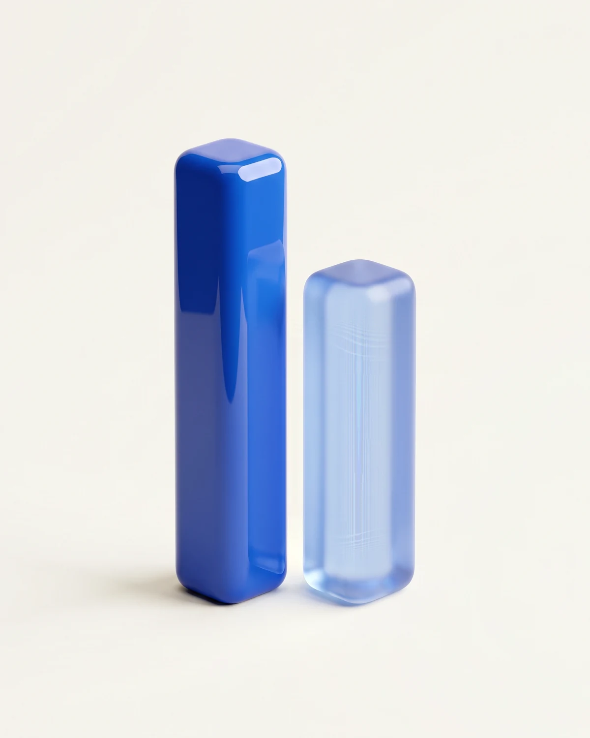 Two uneven rounded bars, one tall cobalt, one shorter translucent blue, the Uneven Bits mark rendered as sculpture